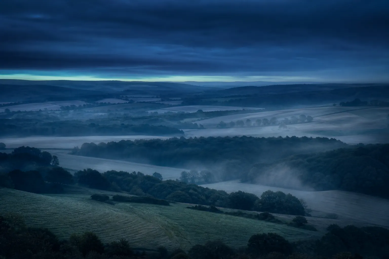 Dusk over rolling farmland and woodland around the Luton and Bedfordshire countryside.